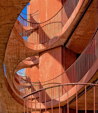 Abstract Orange Spiral Staircase Architecture with Blue Sky