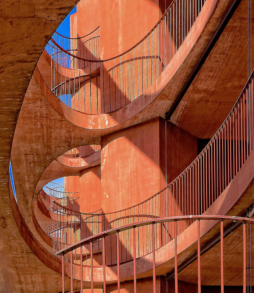 Abstract Orange Spiral Staircase Architecture with Blue Sky