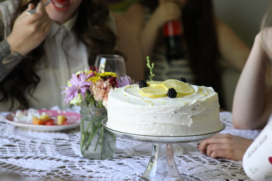 Homemade Lemon Cake with Blackberries on Lace Tablecloth
