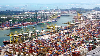 Aerial View of Busy Container Port with Cranes and Ships