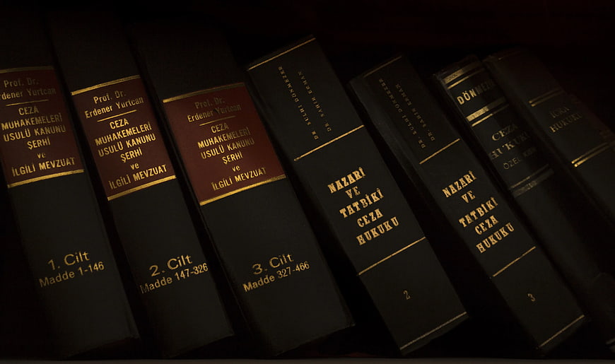 Dark Law Books on Shelf with Gold Lettering