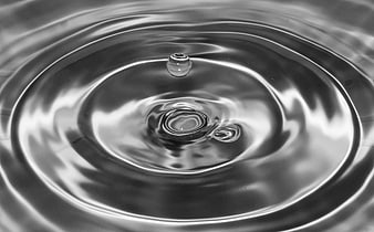 Black and white water drop splash with ripples