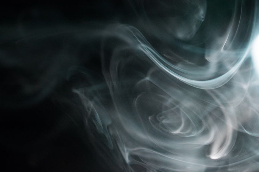 Abstract swirling smoke against dark background