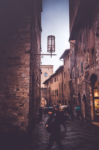 Rainy Medieval Street in San Gimignano with Pedestrians