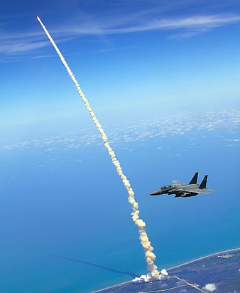 F-15 Fighter Jet Flying Near Rocket Launch Trail