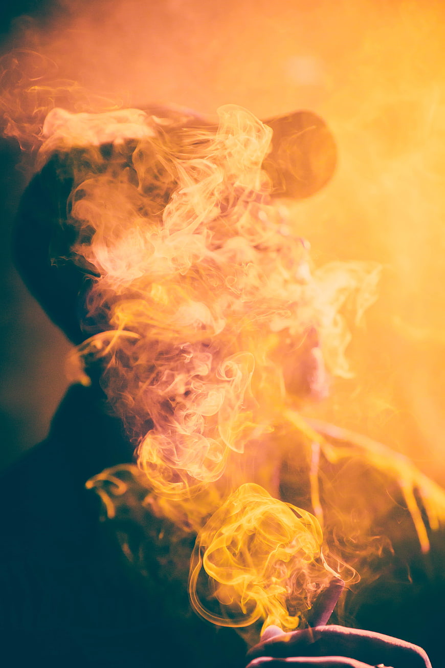 Man Smoking Cigarette with Dramatic Orange Smoke