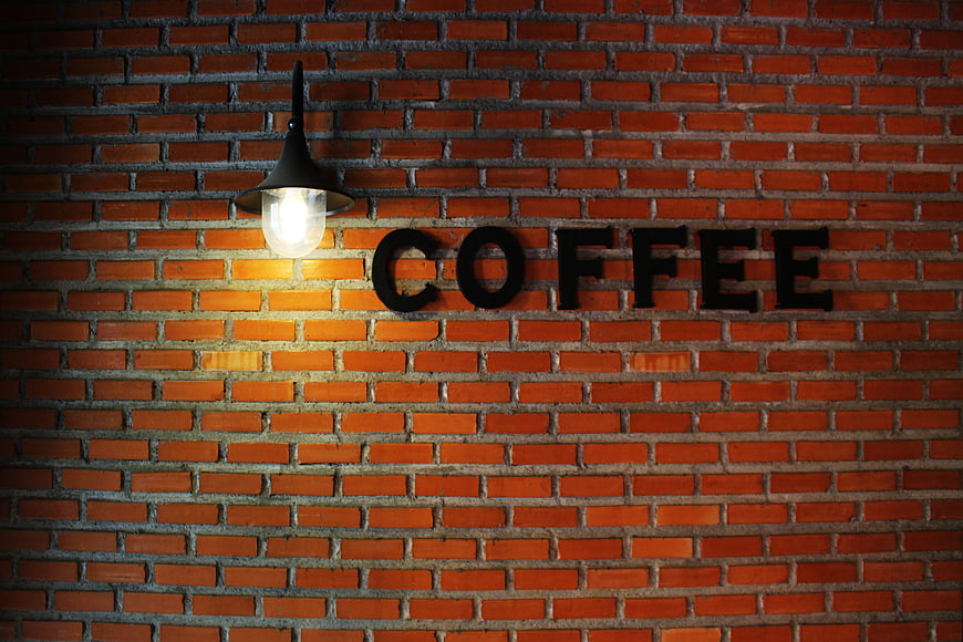 Coffee Sign on Brick Wall with Lamp