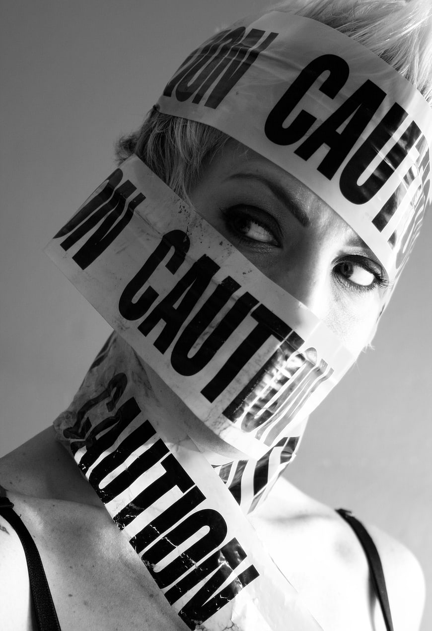 Woman with Caution Tape Wrapped Around Face