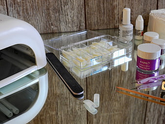 Nail Art Supplies and Gel Polish Kit on Wooden Table