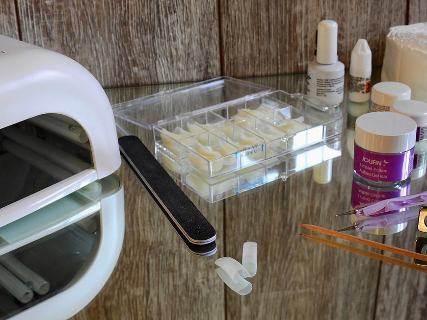 Nail Art Supplies and Gel Polish Kit on Wooden Table