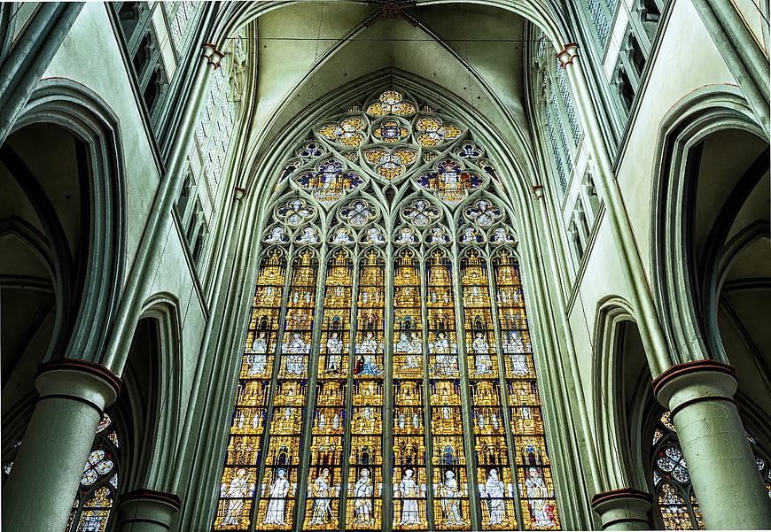Gothic Cathedral Interior with Golden Stained Glass Window
