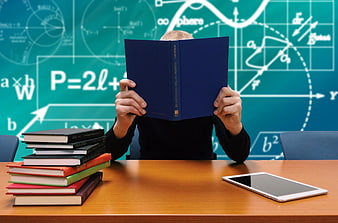 Student studying with books and tablet in front of math formulas
