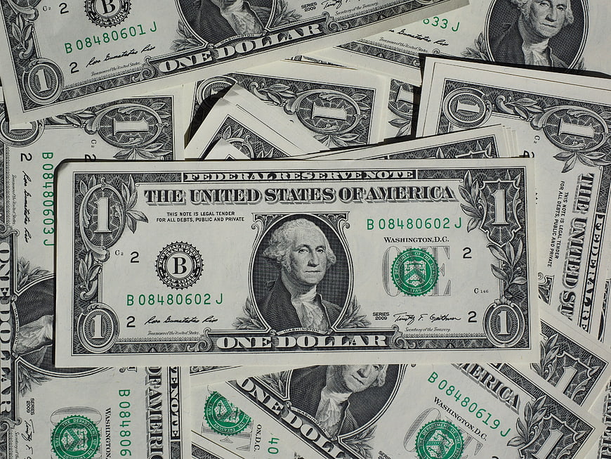 Scattered US One Dollar Bills Flat Lay