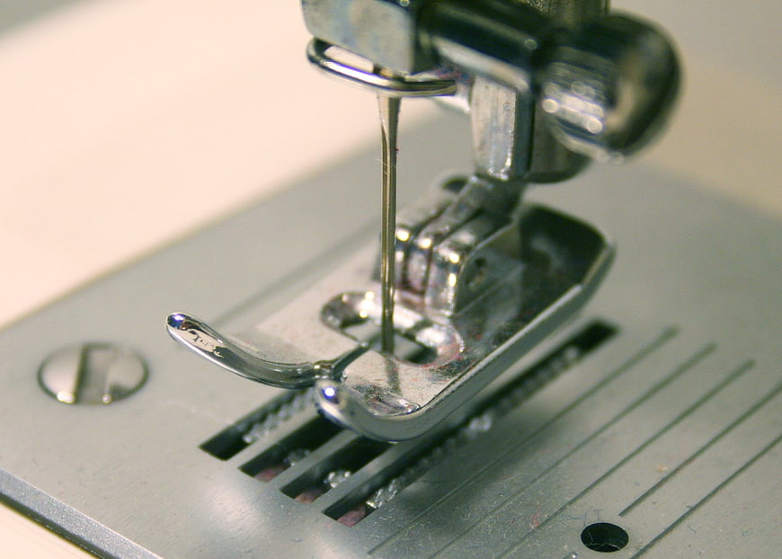 Close-up of sewing machine needle and presser foot mechanism