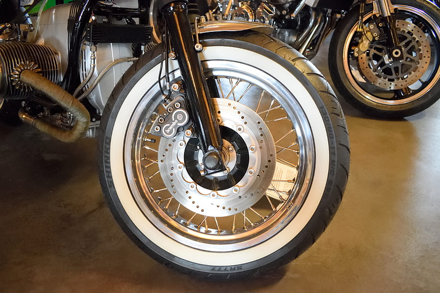 Close-up of vintage motorcycle wheel with whitewall tire