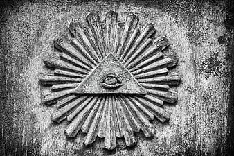 Weathered All-Seeing Eye Symbol Carved in Wood
