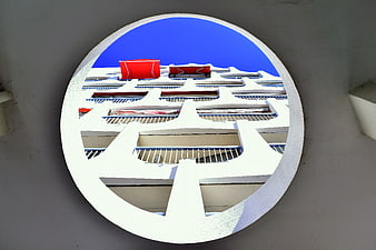 Modern white apartment building viewed through circular window frame