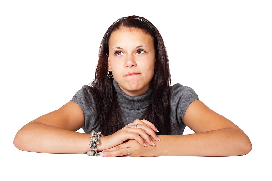Young Woman with Pouting Expression on White Background