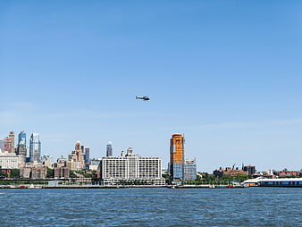 Helicopter Flying Over Brooklyn Skyline and Water