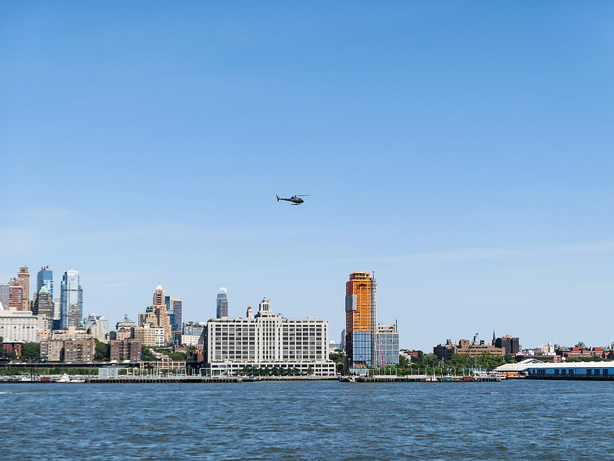Helicopter Flying Over Brooklyn Skyline and Water
