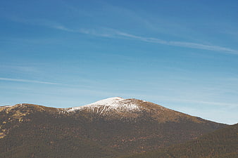 Snow-capped mountain peak against a clear blue sky