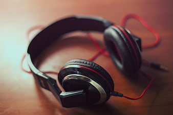 Black and Red Wired Headphones on Wooden Surface