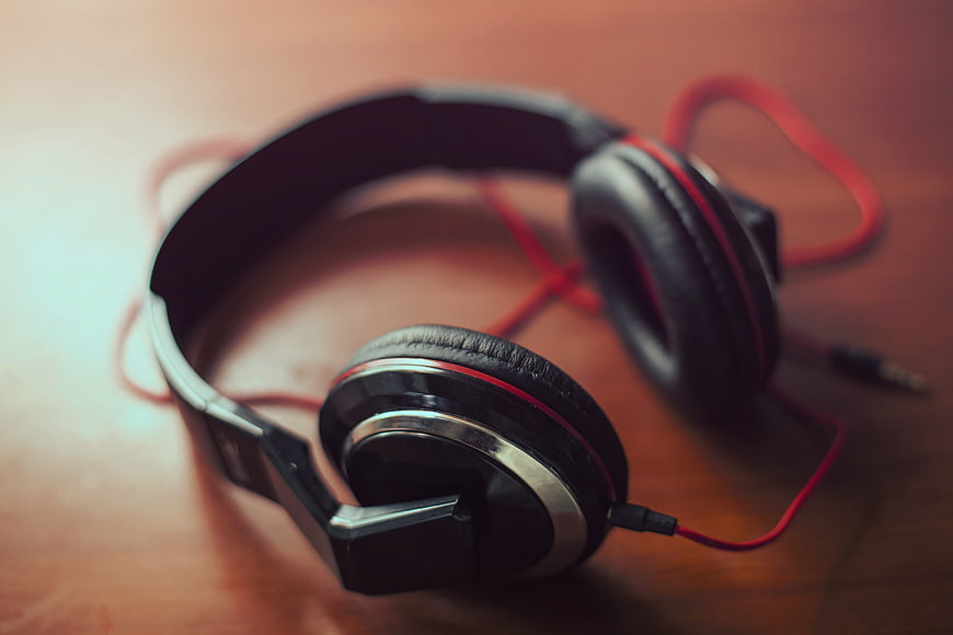 Black and Red Wired Headphones on Wooden Surface