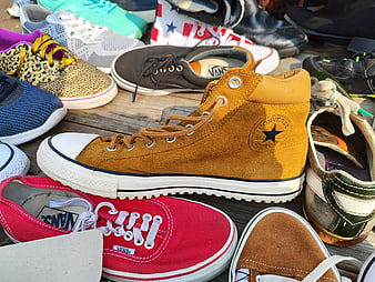 Collection of colorful sneakers and casual shoes on wooden planks