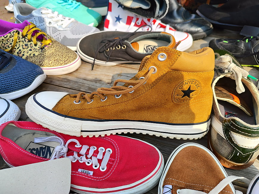 Collection of colorful sneakers and casual shoes on wooden planks