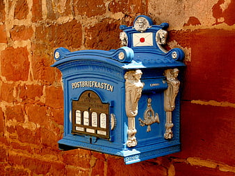 Vintage Blue Ornate Mailbox on Red Brick Wall