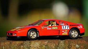 Red Ferrari F40 Model Car on Stone Wall