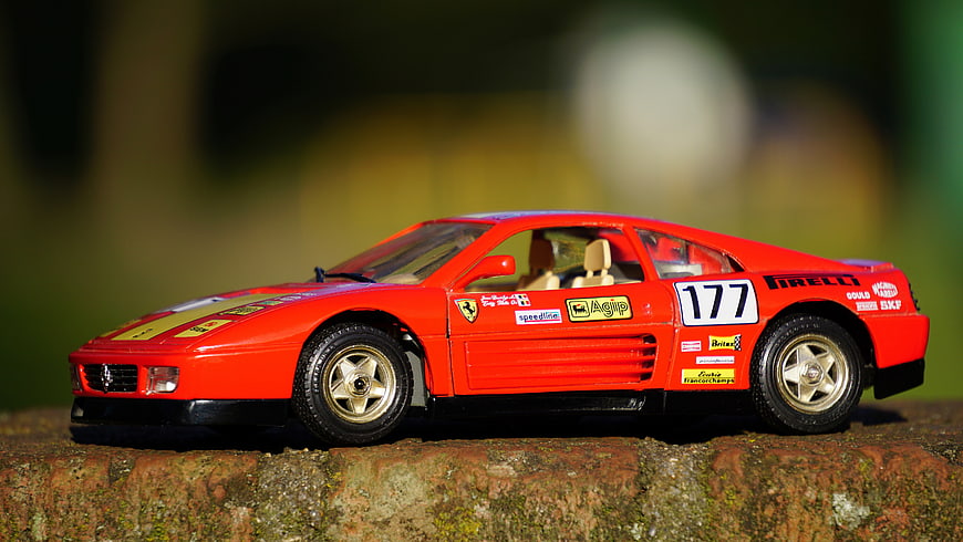 Red Ferrari F40 Model Car on Stone Wall