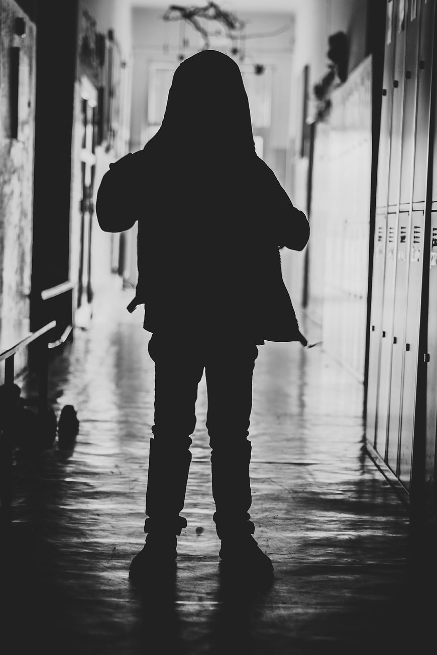 Silhouette of Child Standing in School Hallway