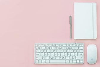 Minimalist Pink Workspace Flat Lay with Keyboard and Notebook