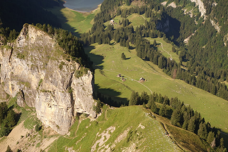 Aerial View of Alpine Valley with Cliff and Lake