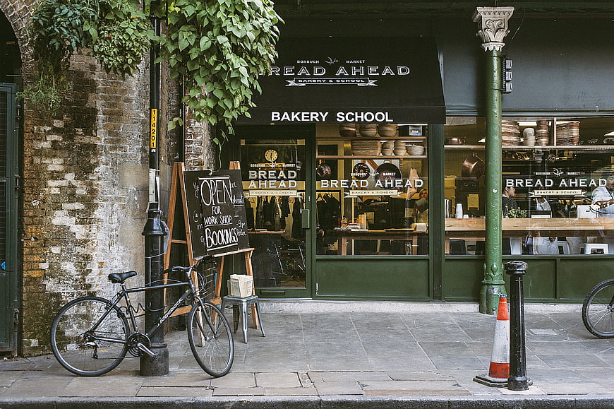 Bread Ahead Bakery School storefront with bicycle and chalkboard sign