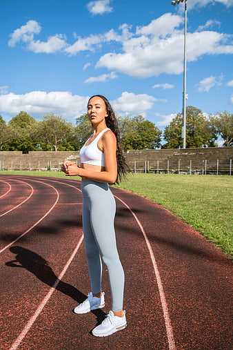 Female Athlete Standing on Running Track Outdoors