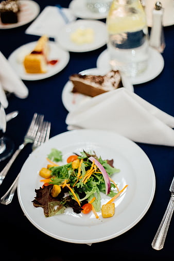 Fresh salad with croutons on formal dining table
