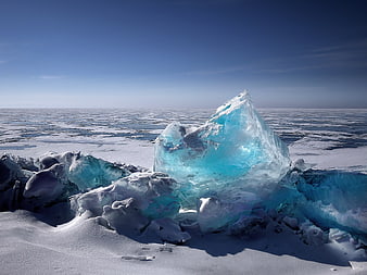 Translucent Blue Iceberg on Frozen Lake Baikal Winter Landscape