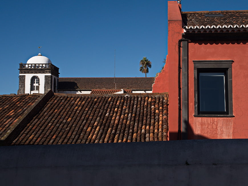 Colorful Spanish Architecture with Red Wall and Blue Sky