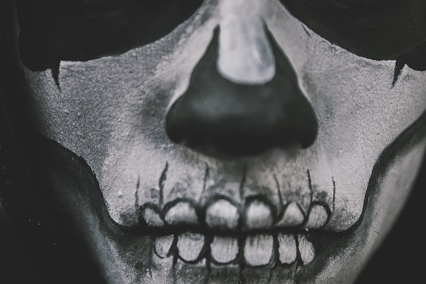 Close-up of skull makeup on a man's face