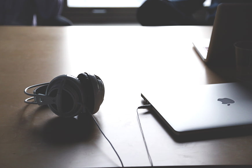 Headphones and Laptop on Wooden Desk