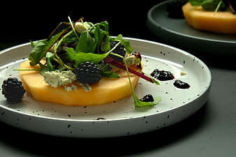 Gourmet melon salad with blackberries, blue cheese, and balsamic glaze