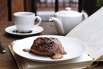 Chocolate Lava Cake with Tea and Open Book on Wooden Table
