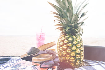 Tropical beach vacation flat lay with pineapple and sunglasses