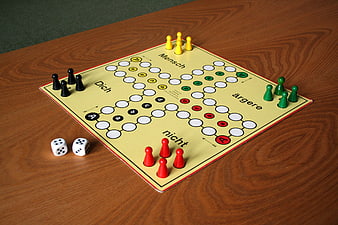 Mensch ärgere dich nicht board game with dice and pieces on wooden table
