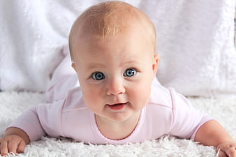 Adorable Baby Girl Lying On White Fluffy Rug