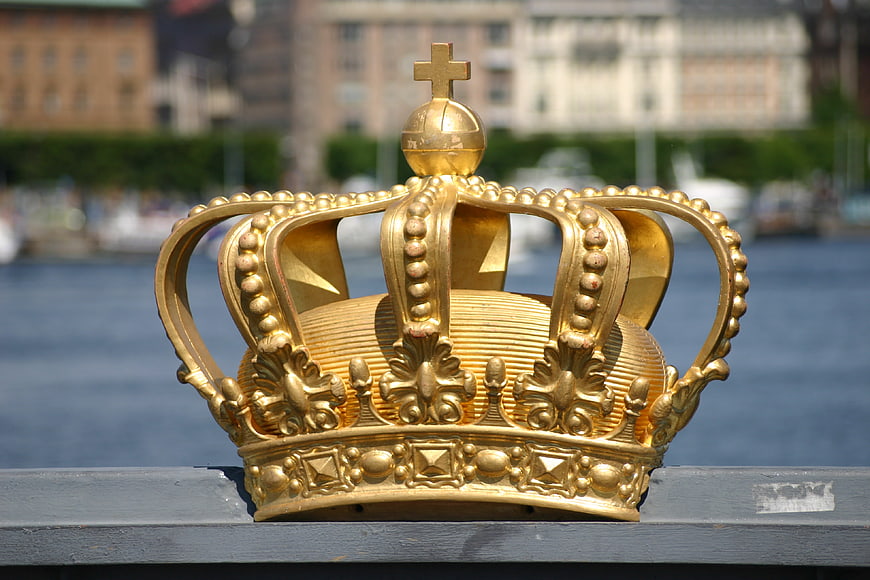 Golden Crown Sculpture on Bridge Railing in Stockholm