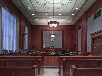 Empty wooden courtroom interior with judge bench and jury seating