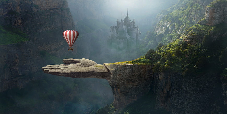 Fantasy landscape with stone hand holding hot air balloon and castle